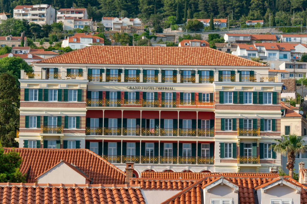 Hospitality & Lifestyle Assets Stunning facade of a luxury hotel in Dubrovnik, showcasing classic architecture under a summer sky.